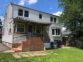 Hartford house for rent - A house with a grey siding and a white roof is shown.