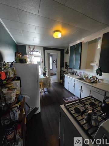 Kalamazoo apartment for rent - A kitchen with a stove top oven and a refrigerator.