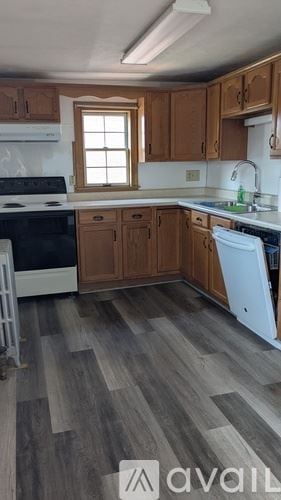 Hanover apartment for rent - A kitchen with wooden cabinets and a white dishwasher.
