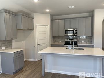 Anna house for rent - A kitchen with a white countertop and grey cabinets.