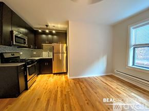 Chicago apartment for rent - A kitchen with wooden floors and stainless steel appliances.