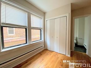 Chicago apartment for rent - A room with a large window and wooden flooring.