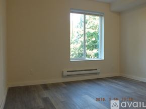 Seattle apartment for rent - A room with a window and a wall-mounted air conditioner.