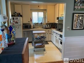 Los Angeles house for rent - A kitchen with a refrigerator, microwave, oven, and sink.