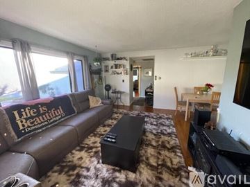 Los Angeles house for rent - A living room with a brown couch and a rug.