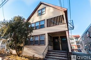 Madison apartment for rent - A house with a balcony and a tree in front of it.