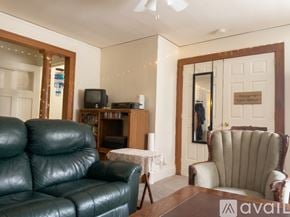 Madison apartment for rent - A living room with a Christmas tree and a brown couch.