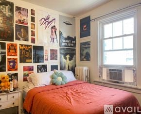 Madison apartment for rent - A bedroom with a bed, a wardrobe, a dresser and a wall hanging.