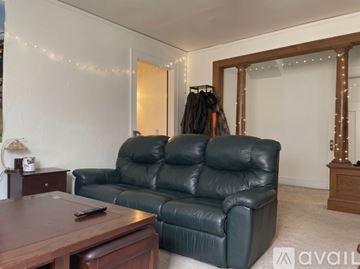 Madison apartment for rent - A Christmas tree stands in a living room with a couch and a coffee table.