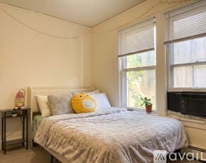 Madison apartment for rent - A kitchen with wooden cabinets and a table with chairs.