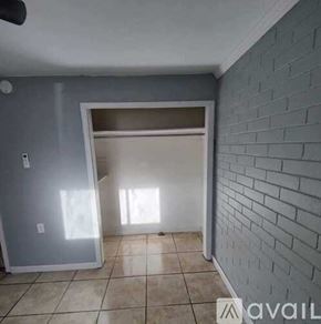 Pensacola apartment for rent - A room with a brick wall and a sliding door.