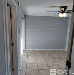 Pensacola apartment for rent - A room with a ceiling fan and tiled floor.