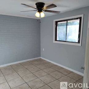 Pensacola apartment for rent - A room with a ceiling fan and a window.