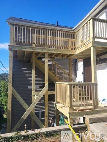 Morgantown apartment for rent - A wooden deck is being built on the side of a house.