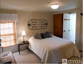 Earlysville apartment for rent - A white house with a grey roof and a deck.