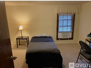 Earlysville apartment for rent - A bedroom with a bed, desk, chair, and window.