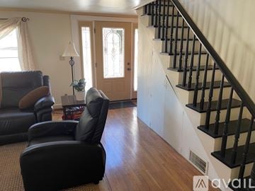 Earlysville apartment for rent - A kitchen with black appliances and wooden cabinets.