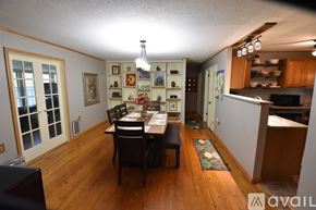 Eureka Springs house for rent - A dining room with a wooden table and chairs.