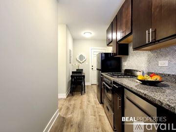 Chicago apartment for rent - A kitchen with a black counter top and a black chair.