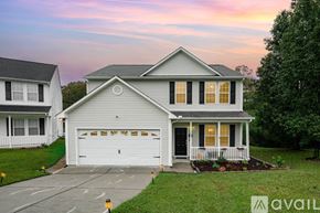 Raleigh house for rent - A house with a white garage door is for sale.