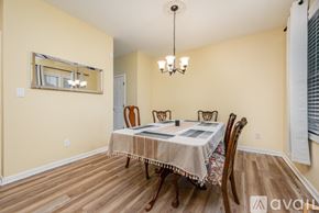 Raleigh house for rent - A dining room with a wooden table and chairs.