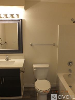 Seattle apartment for rent - A white toilet in a bathroom with a mirror above it.