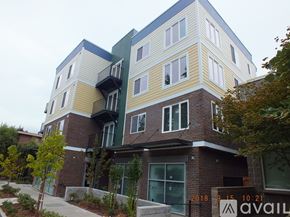Seattle apartment for rent - A modern multi-story building with balconies and windows.