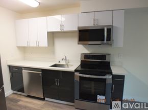 Seattle apartment for rent - A kitchen with black cabinets and appliances is available for rent.