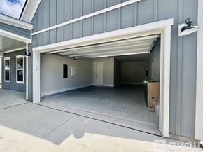 Hardeeville house for rent - A garage with a white door is open and a cardboard box is visible inside.