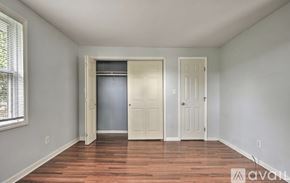 Kingsport house for rent - A room with a wooden floor and two doors, one of which is open.