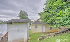 Kingsport house for rent - A house with a shed and a fence in front of it.