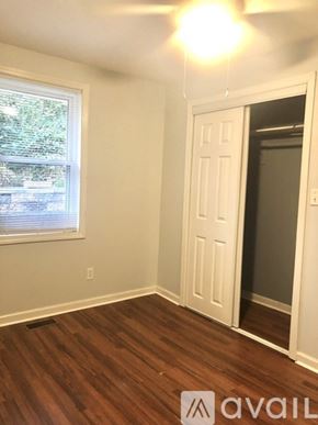 Kingsport house for rent - A room with a wooden floor and a white door.