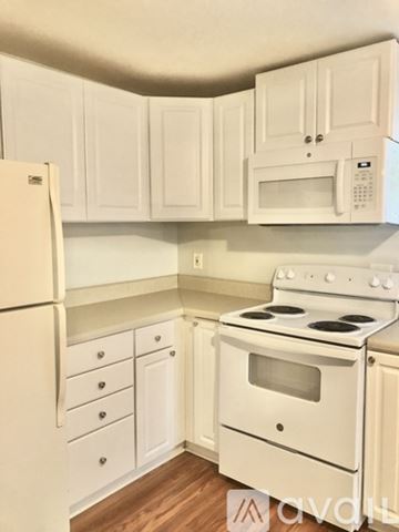 Kingsport house for rent - A white kitchen with a stove, refrigerator, and cabinets.