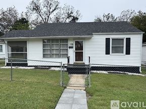 Petersburg house for rent - A white house with a black roof and a fence surrounding it.