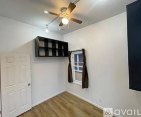 Richmond County house for rent - A room with a ceiling fan and a window with a brown curtain.