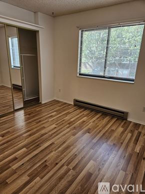 Fort Collins condo for rent - A room with wooden flooring and a window with blinds.