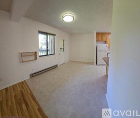Fort Collins condo for rent - A spacious room with a window, a wooden floor, and a white wall.