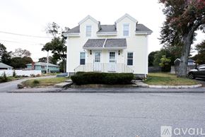 Braintree townhouse for rent - A white house with a black fence in front of it.