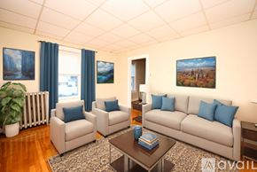 Braintree townhouse for rent - A living room with a white couch, two chairs, and a coffee table.