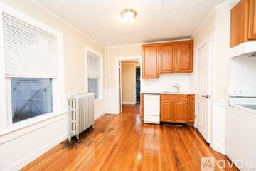 Braintree townhouse for rent - A kitchen with wooden cabinets and white appliances.