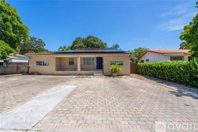 Miami condo for rent - A house with a driveway in front of it.