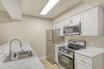 Mesa apartment for rent - A black stove top oven with a black refrigerator in a kitchen.