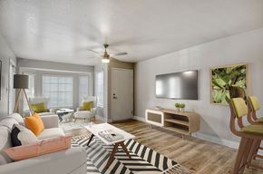 Mesa apartment for rent - A living room with a couch, a table, a plant, and a fireplace.