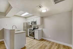 Mesa apartment for rent - A bedroom with a red bed and a mirror above a vanity.