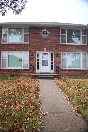 Fremont apartment for rent - A brick house with a white door and windows.