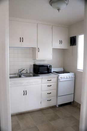 Fremont apartment for rent - A white kitchen with a microwave, oven, and sink.