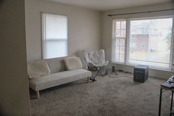 Fremont apartment for rent - A living room with a grey couch and a chair.