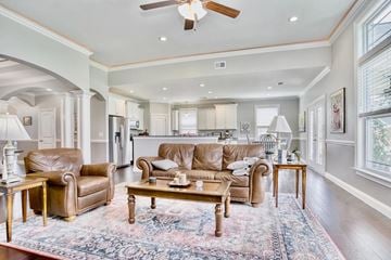 Greer house for rent - A living room with a brown leather couch and a rug.