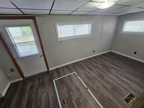 Lima house for rent - A room with wooden flooring and two windows.