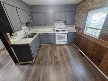 Lima house for rent - A kitchen with a stove top oven and a sink.